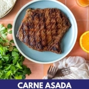 Carne asada sits on a blue plate with the words Carne Asada Marinade and the web address for two cloves kitchen dot com.
