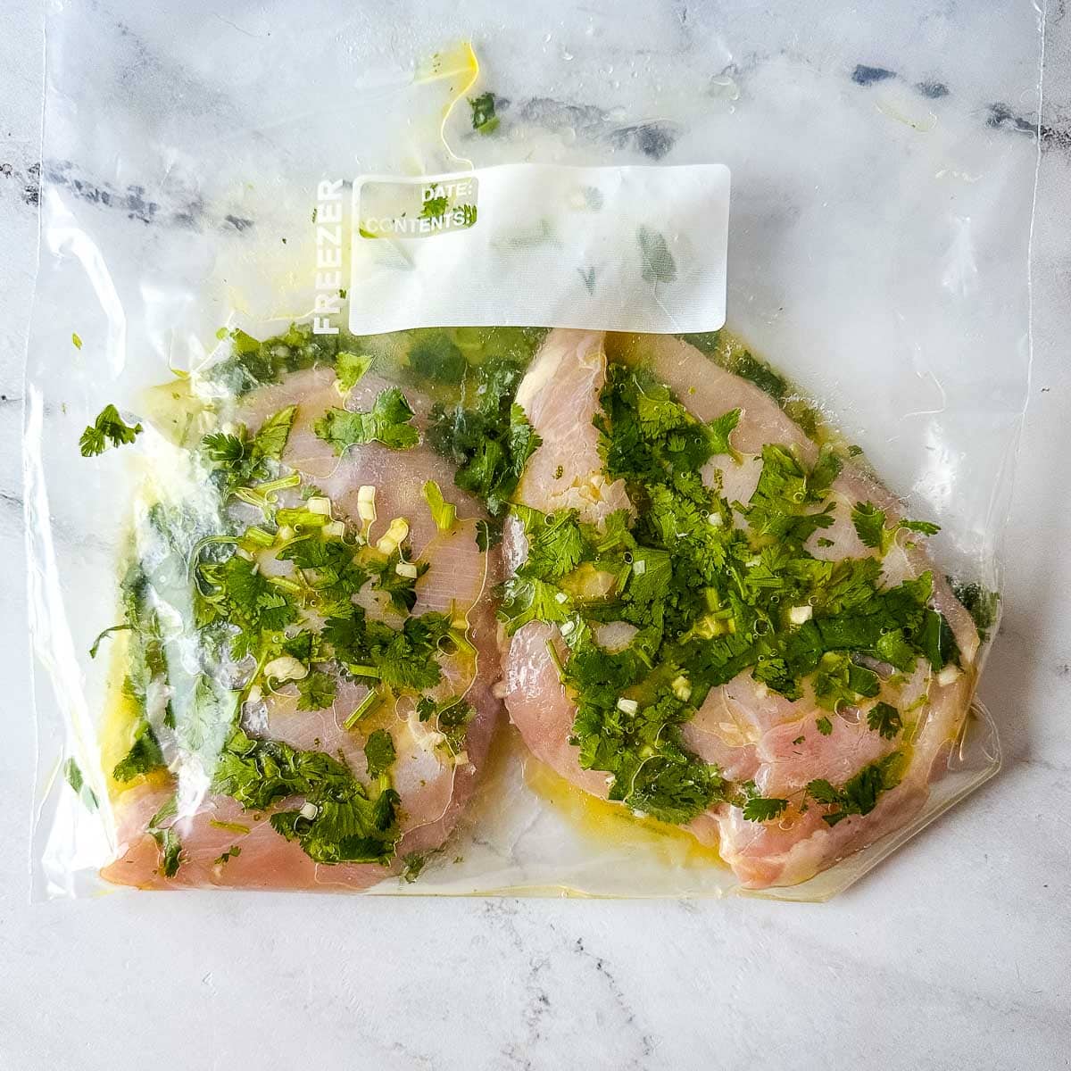 Chicken marinating in lime cilantro marinade.