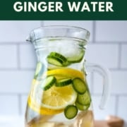 An image with infused water in a glass pitcher, the words cucumber lemon ginger water, and the web address for two cloves kitchen dot com.