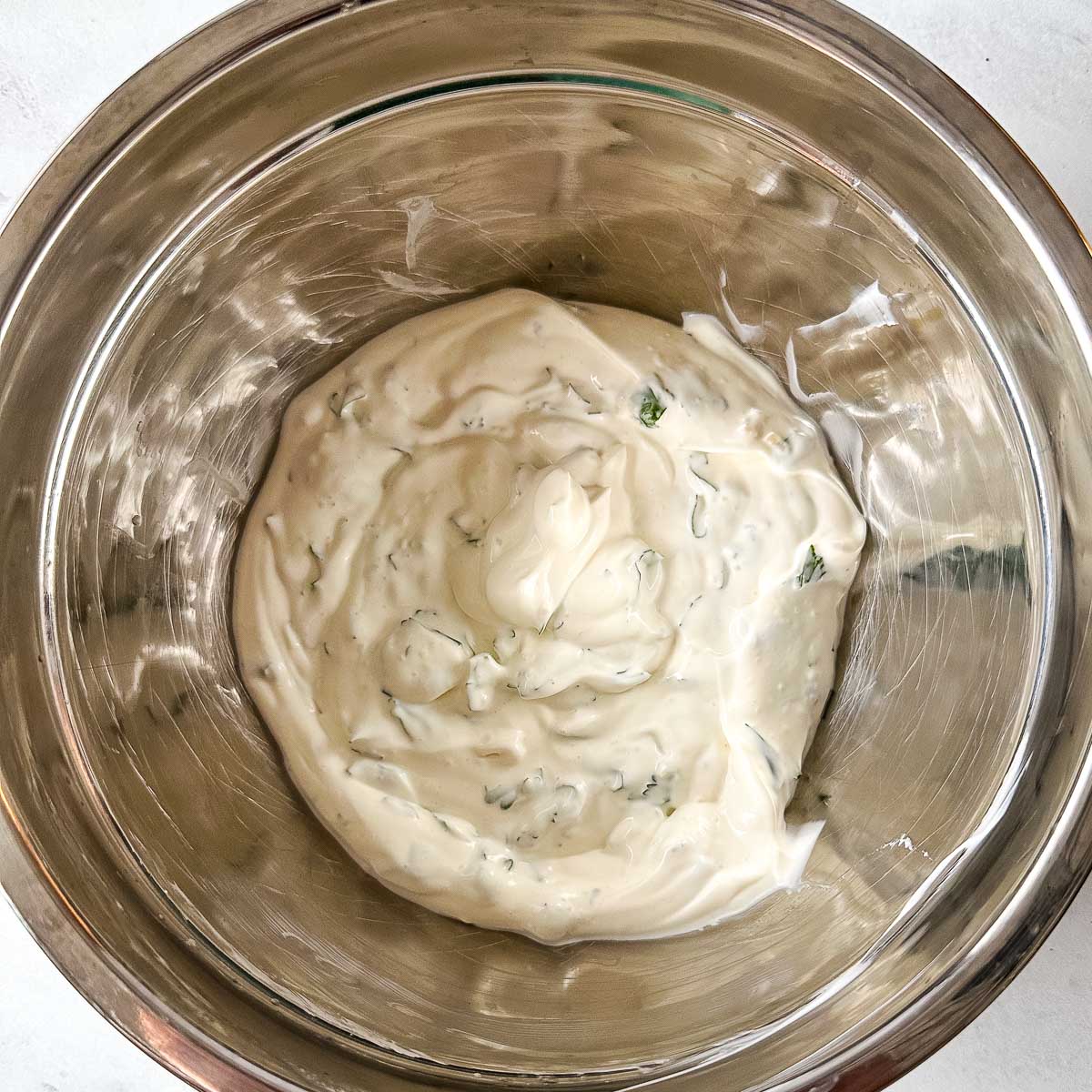 Cilantro lime crema in a silver bowl.
