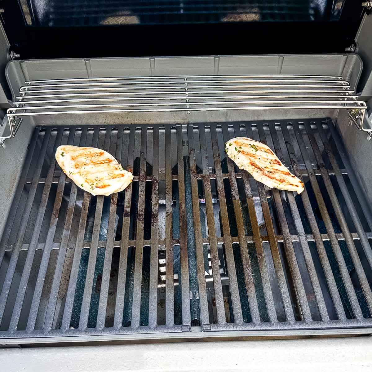 Chicken grilling on a gas grill.