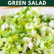 Image shows a green salad with the words Greek green salad and the web address for two cloves kitchen dot com.