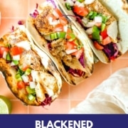 Fish tacos on a peach tile background with the words Blackened Fish Tacos and the web address two cloves kitchen dot com.