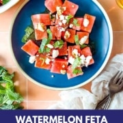 Watermelon salad on a peach tile background with the words watermelon mojito salad and the wed address two cloves kitchen dot com.