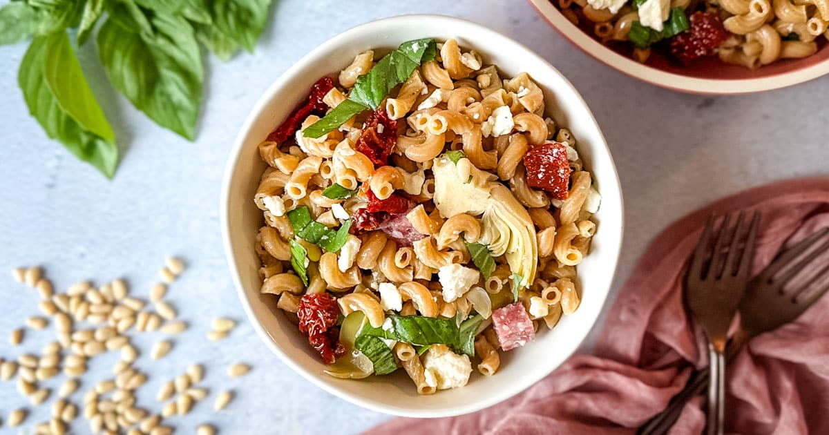 Whole wheat pasta salad in white dish.