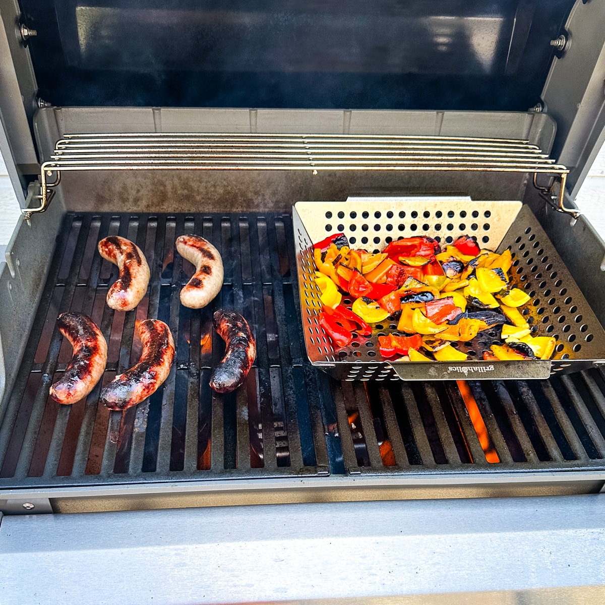Grilled sausages and peppers on a grill.