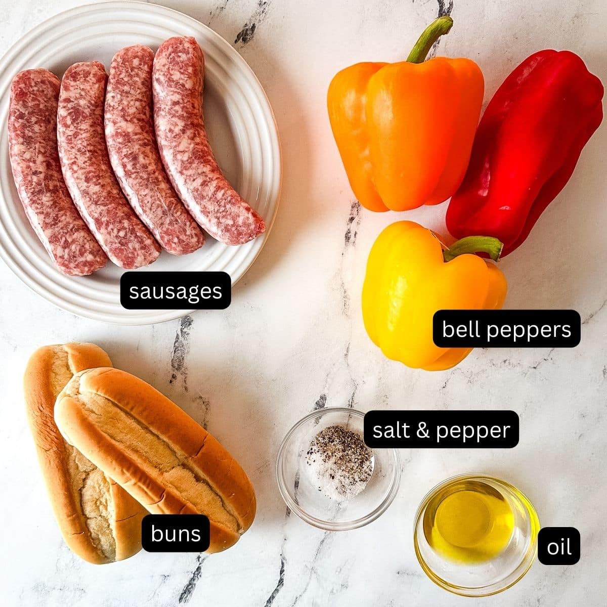 The labeled ingredients for sausage and pepper sandwiches on a white marble counter.