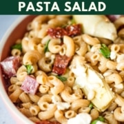 Image shows a dish of pasta salad with the words whole wheat pasta salad and the web address two cloves kitchen dot com.