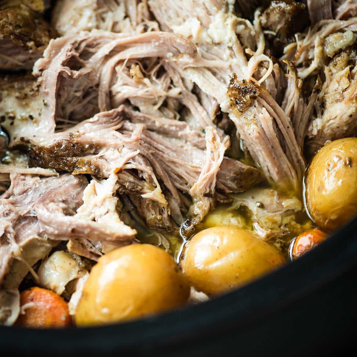 Slow cooker pulled pork with potatoes and carrots.
