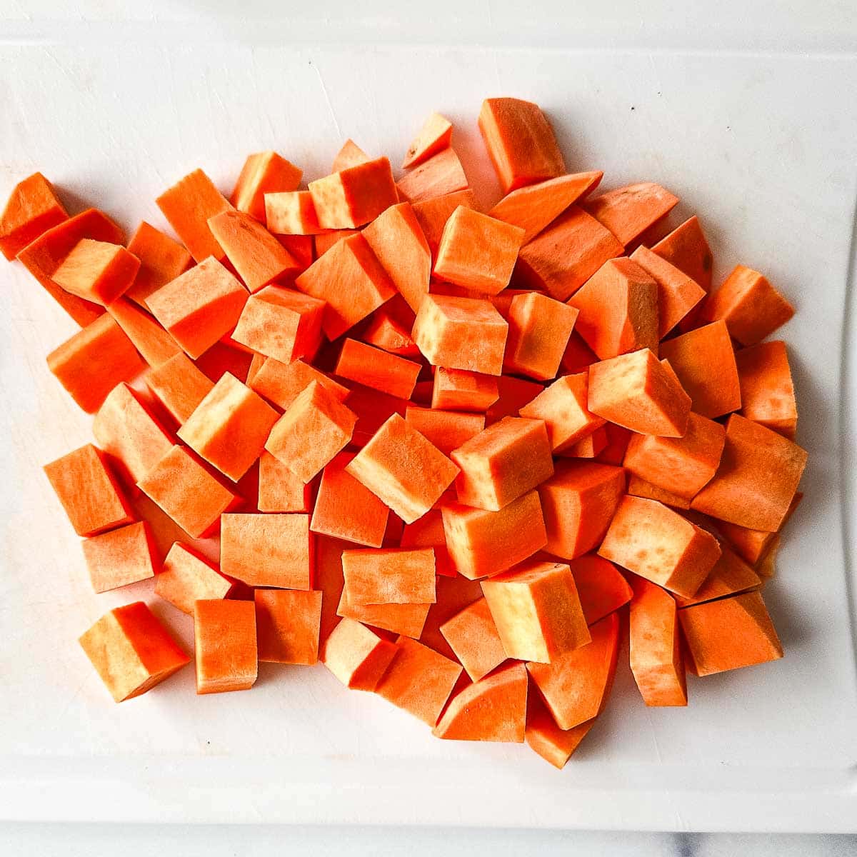 Chopped carrots on a cutting board.