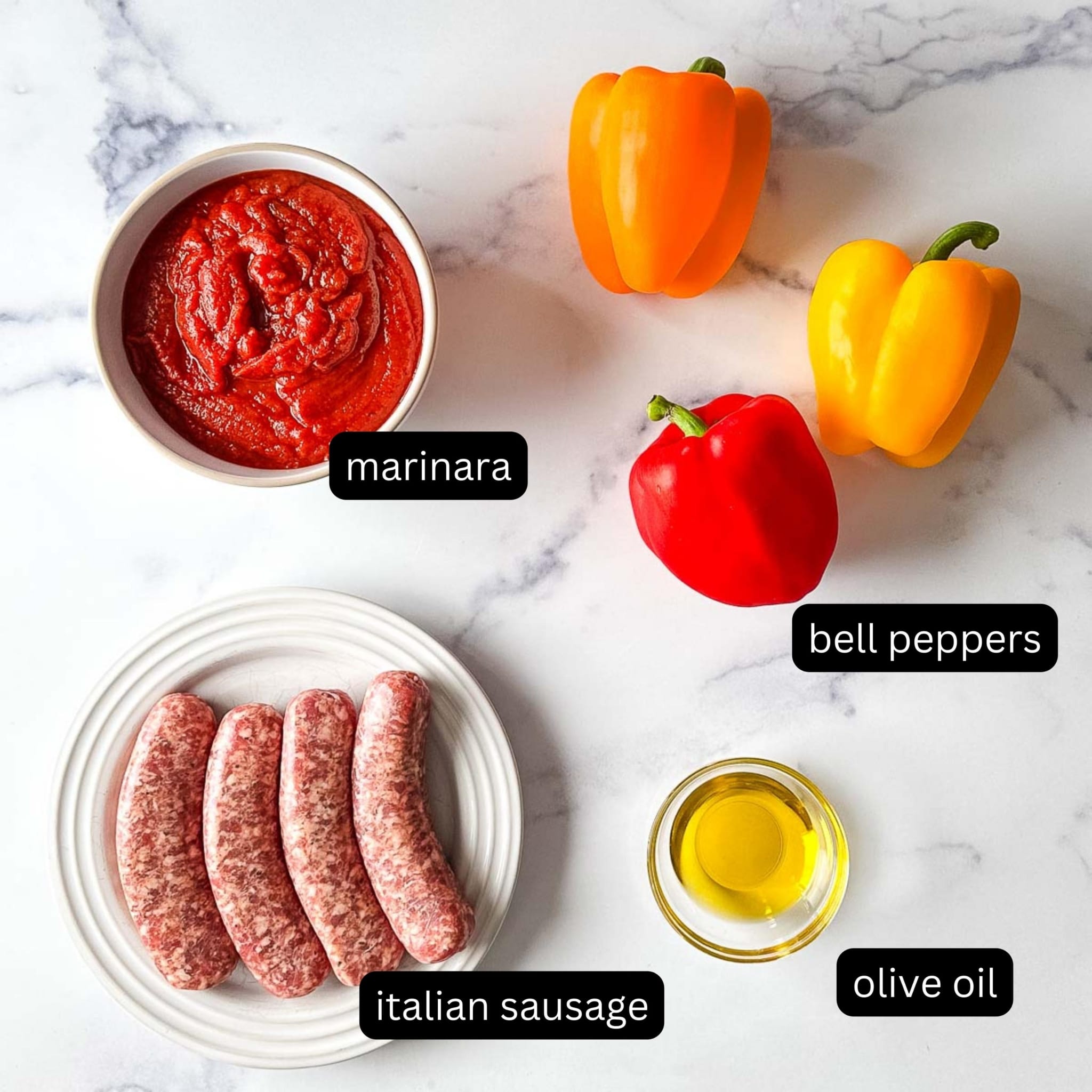 Ingredients for a slow cooker sausage and peppers recipe on a marble countertop.