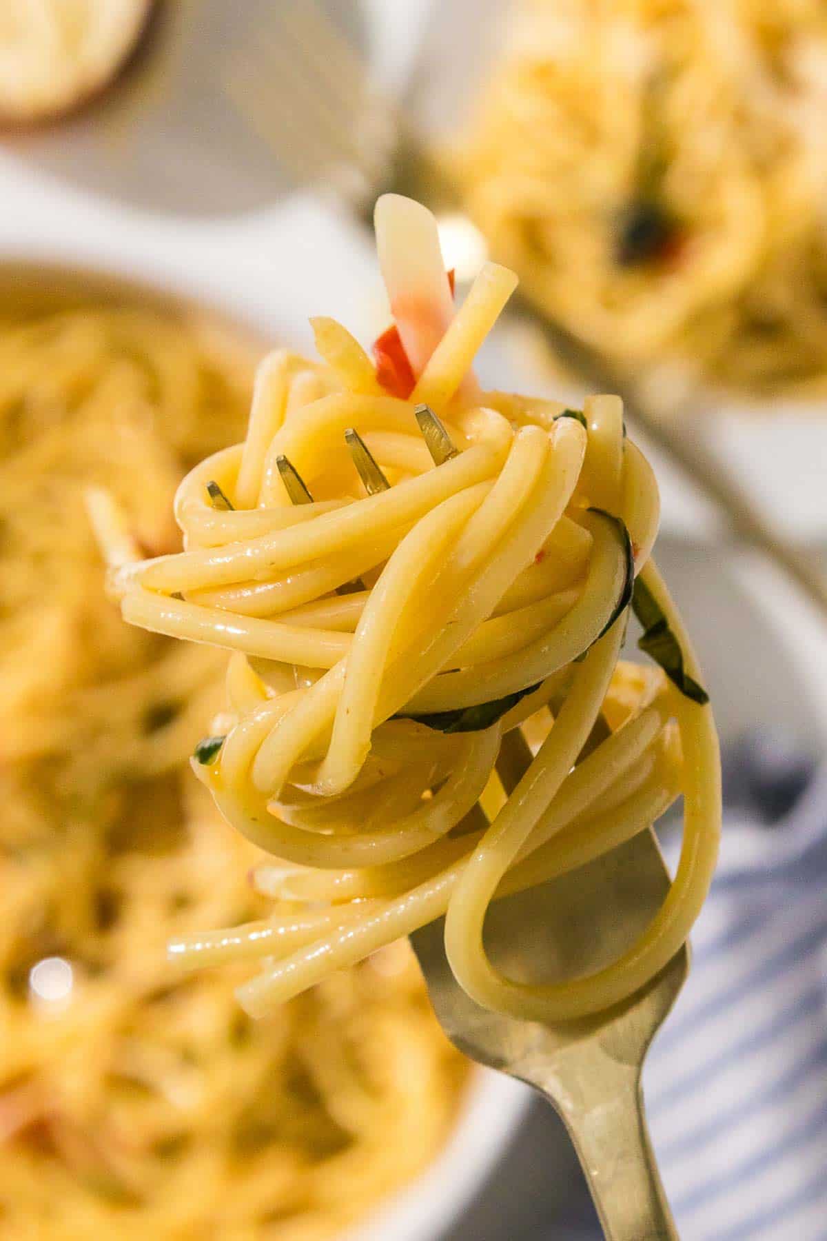 A fork is holding twirled spaghetti.