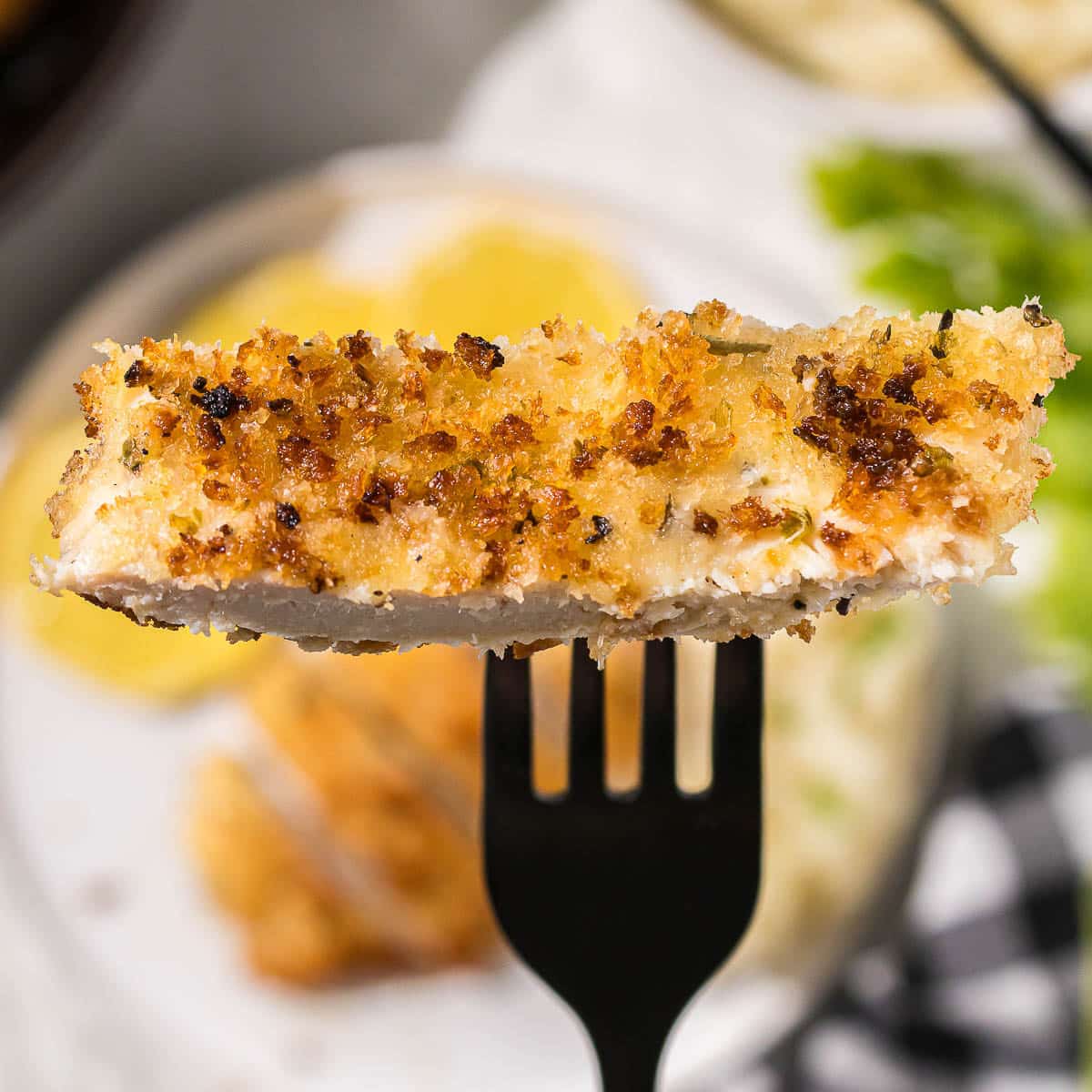 A piece of breaded chicken on a fork.