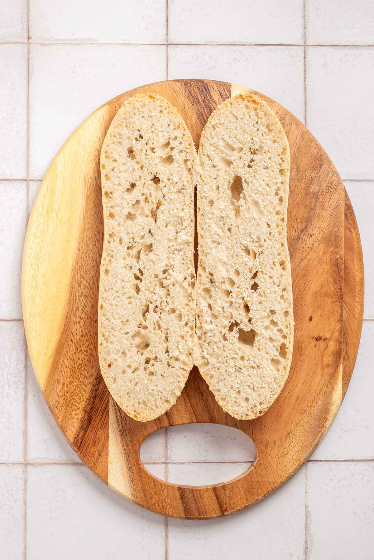 Two slices of bread on a wooden cutting board.