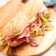 A sub sandwich on a wooden board.