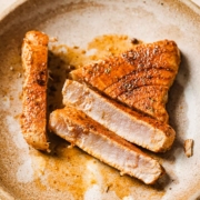 A plate with sliced blackened ahi tuna on it.