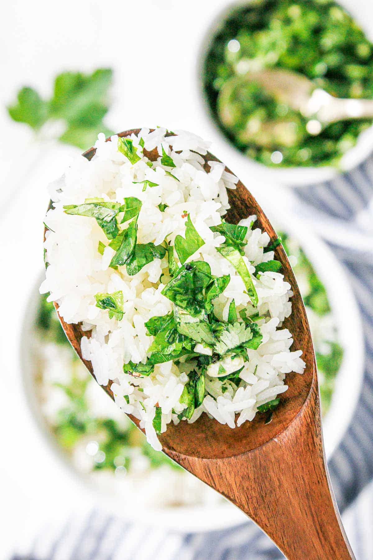 A wooden spoon filled chimichurri rice.