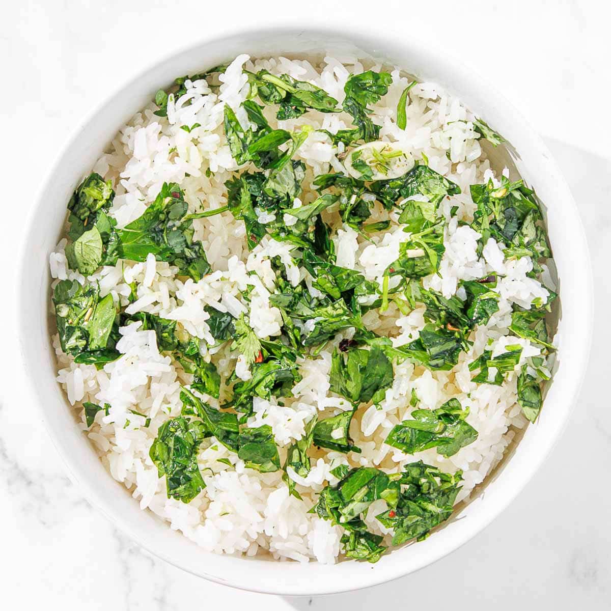 A white bowl filled with chimichurri rice.
