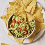 A bowl of 4-ingredient guacamole surrounded by tortilla chips.