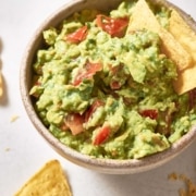 A bowl of 4-ingredient guacamole with tortilla chips.