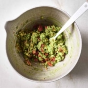 Guacamole in a bowl with a spoon.