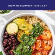 A bowl filled with shrimp, black beans, quinoa, sautéed zucchini, and chimichurri sauce, viewed from above.